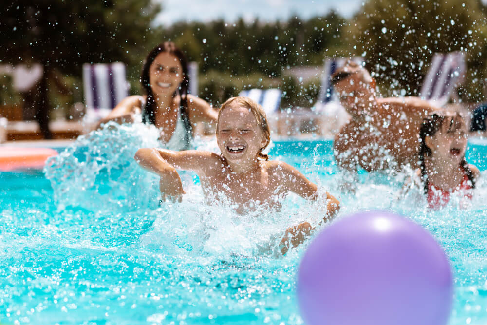 Family playing in pool